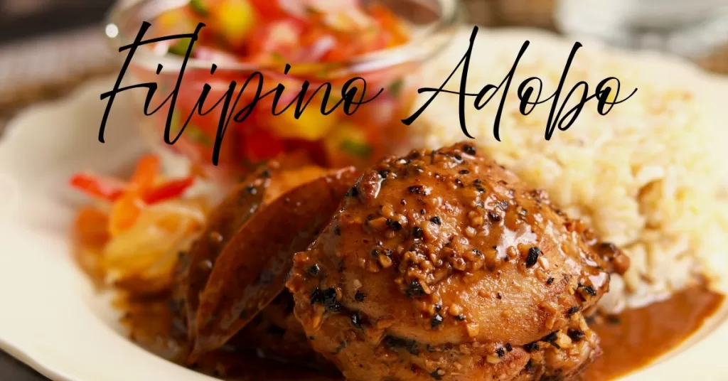 Filipino chicken adobo with rice and tomato mango salad on a plate.