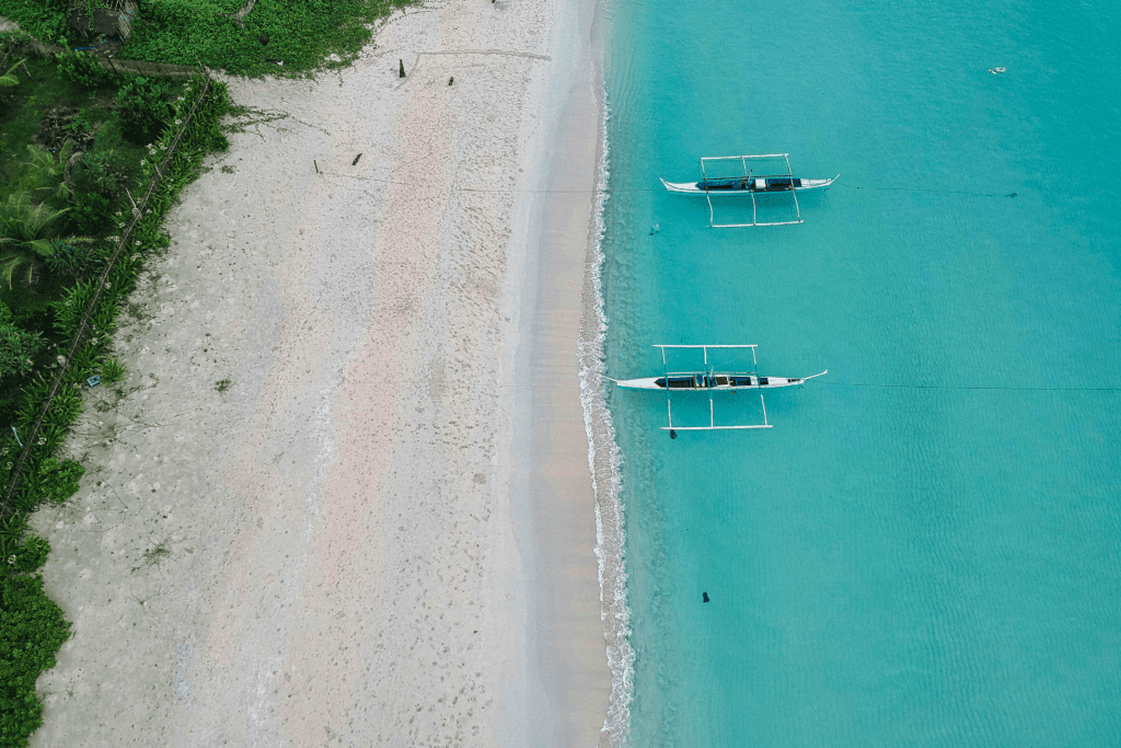 top view of two boats on the beach