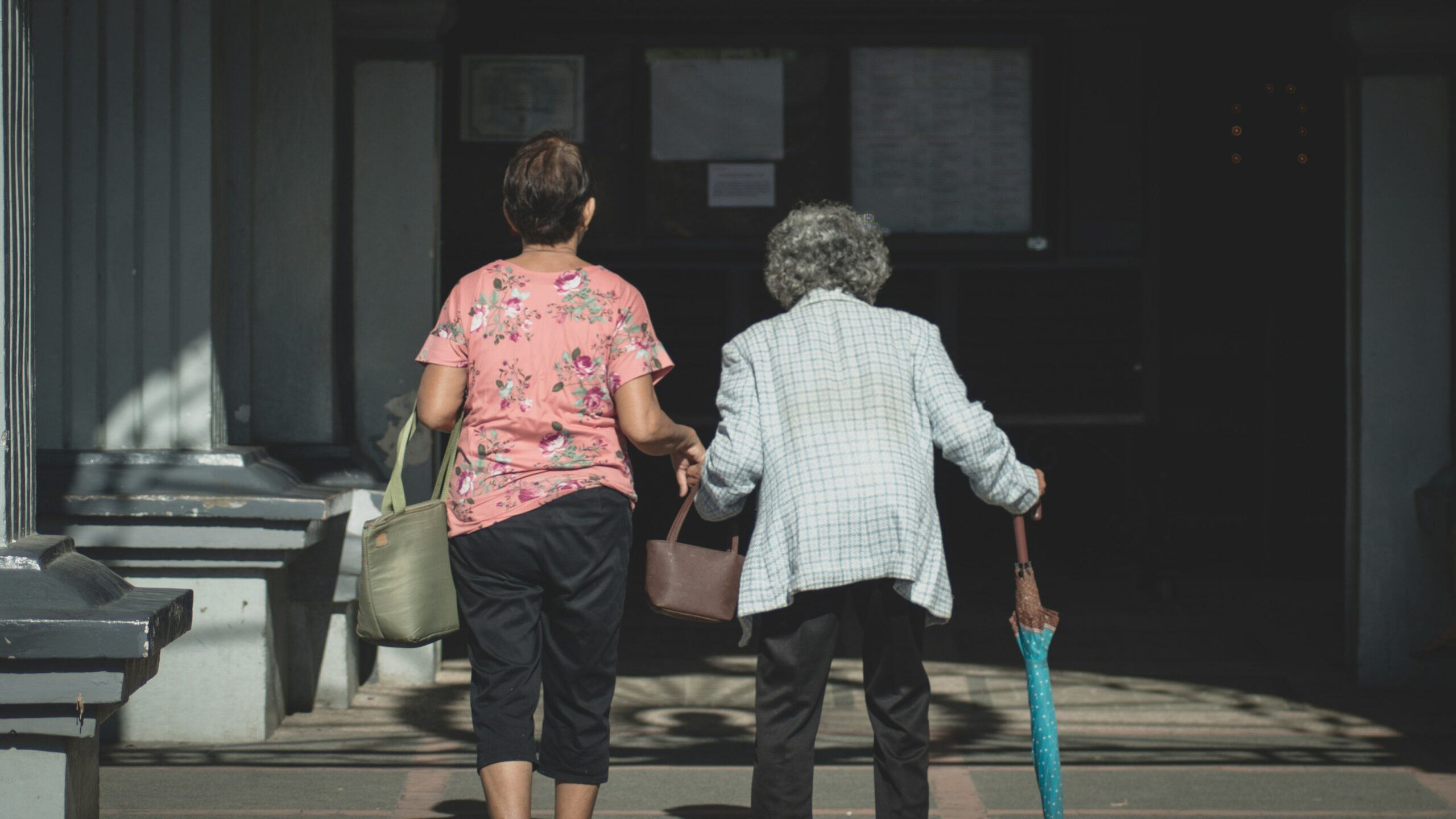 Two women walk together, reflecting the strong sense of care and respect for elders deeply rooted in Filipino culture and family values.