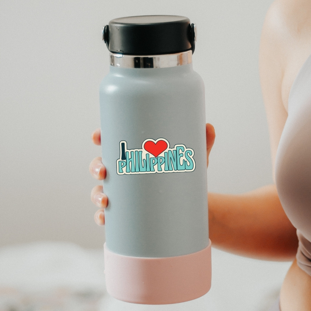 Gray water bottle with ‘I love Philippines’ design held in hand.