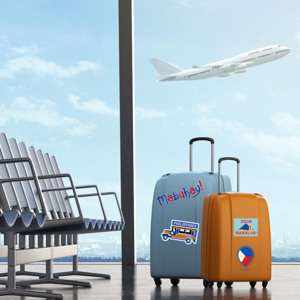 Blue and orange suitcases with Filipino stickers at airport with plane in background.